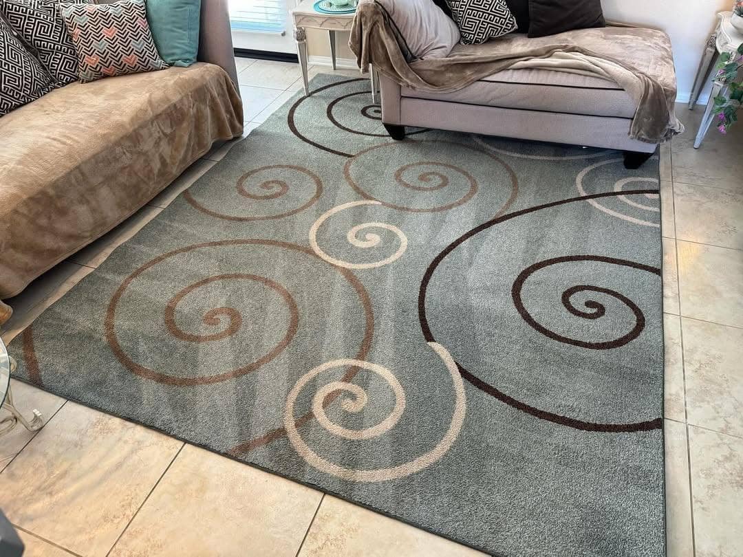 A freshly cleaned area rug in a bright living room by Crystal Clear Carpet