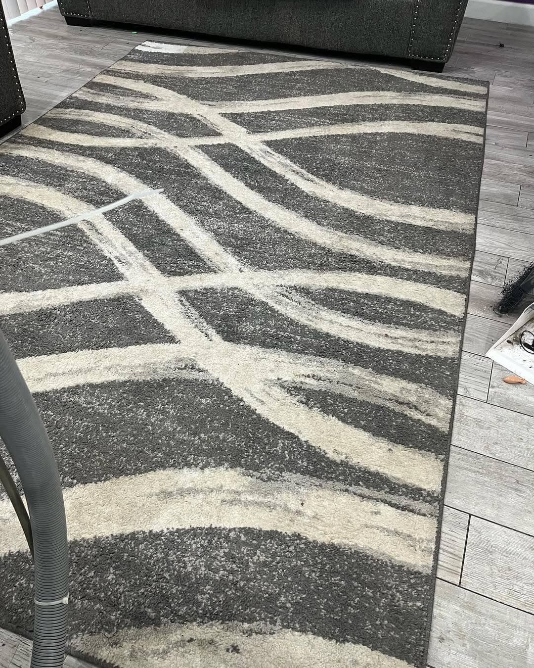 Patterned area rug before cleaning, matted and dull